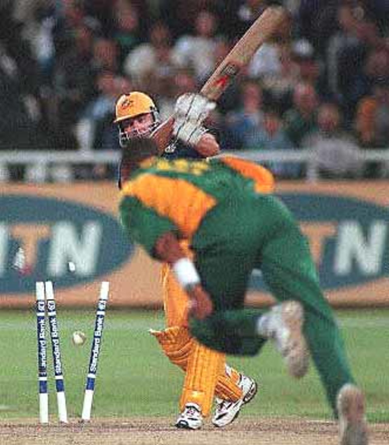 Bails fly as Australian cricketer and 'man of the match' Damian Martyn is bowled out by South African Makhaya Ntini for 50 during the limited overs international played at Newlands in Cape Town 14 April 2000. The match is the second of three one day internationals being played in South Africa. The Australians beat the South Africans scoring 145/9 after 26 overs.