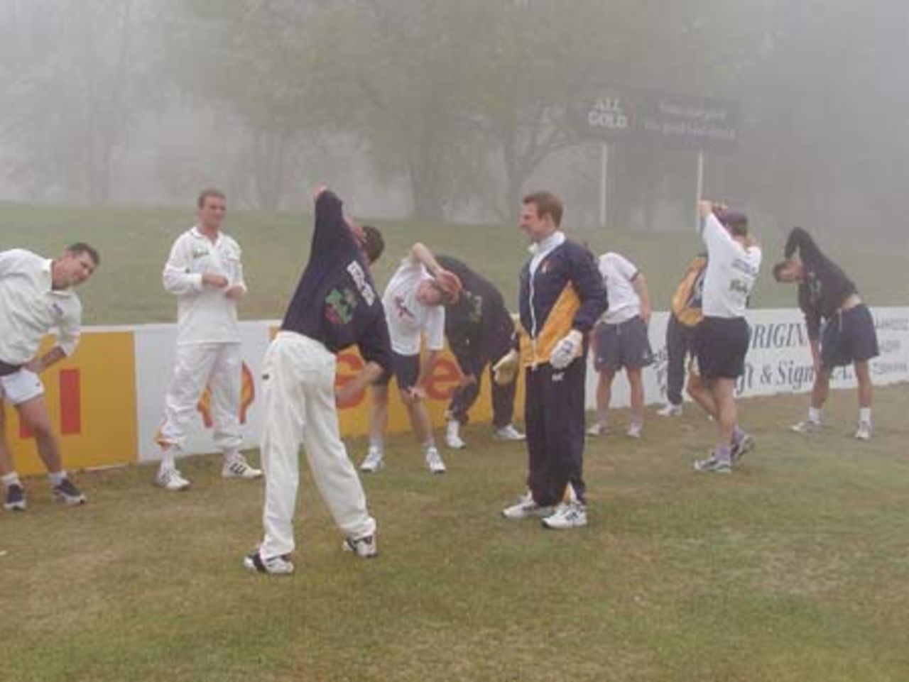 Hampshire players doing stretching excersises waiting for the early morning fog to lift