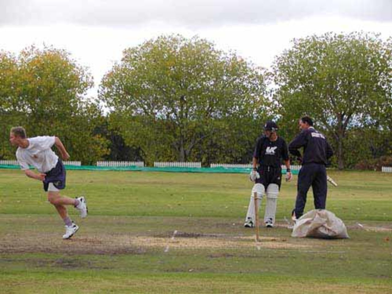 James Hamblin follows through watched closely by coach Jimmy Cook