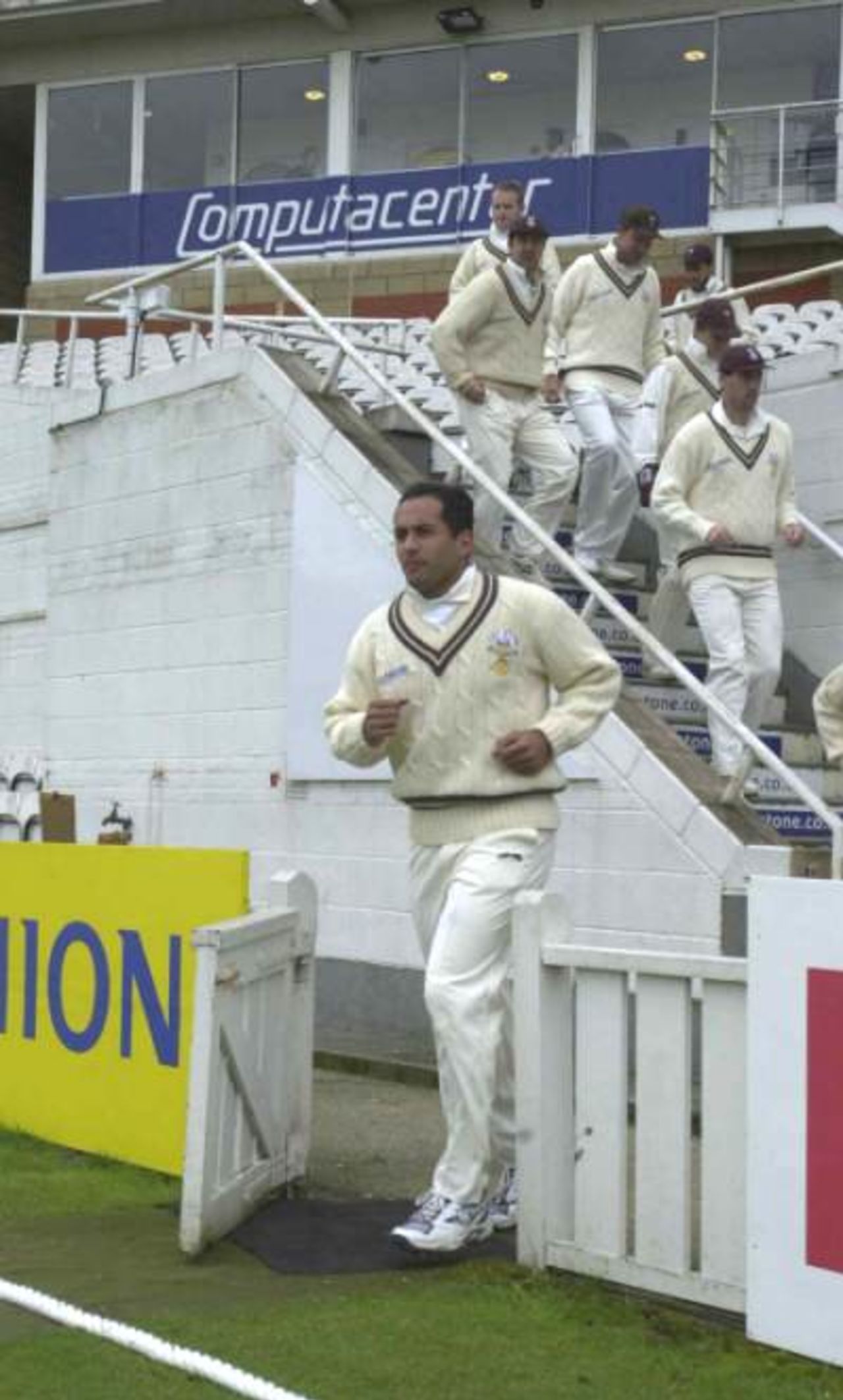 Adam Hollioake leads  out the Champions on the first day of the CricInfo Championship at The Oval, 20th April 2001