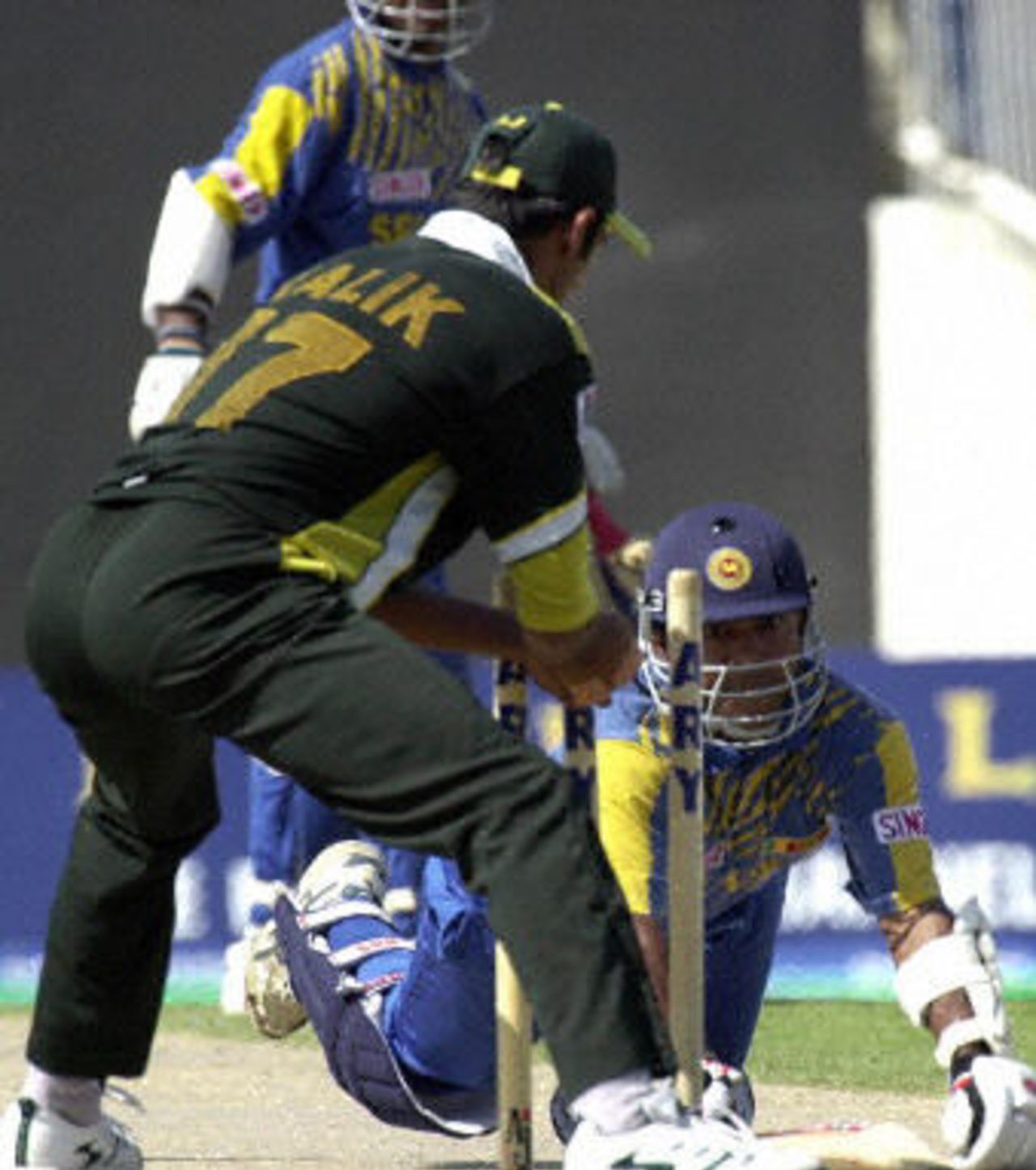 Romesh Kaluwitharana gains his ground as Shoaib Malik uproots the stumps, Final at Sharjah, Pakistan v Sri Lanka, 20 April 2001