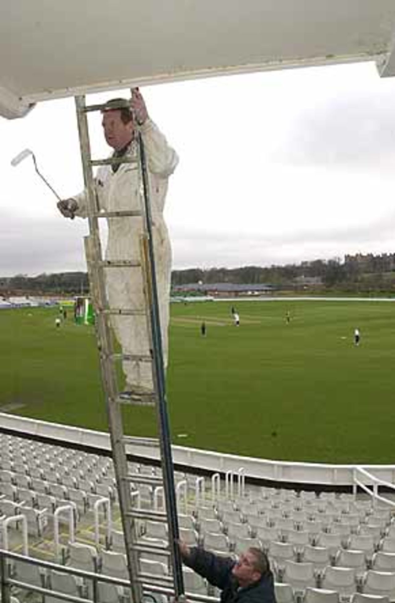 Players take practice as the painters get to work