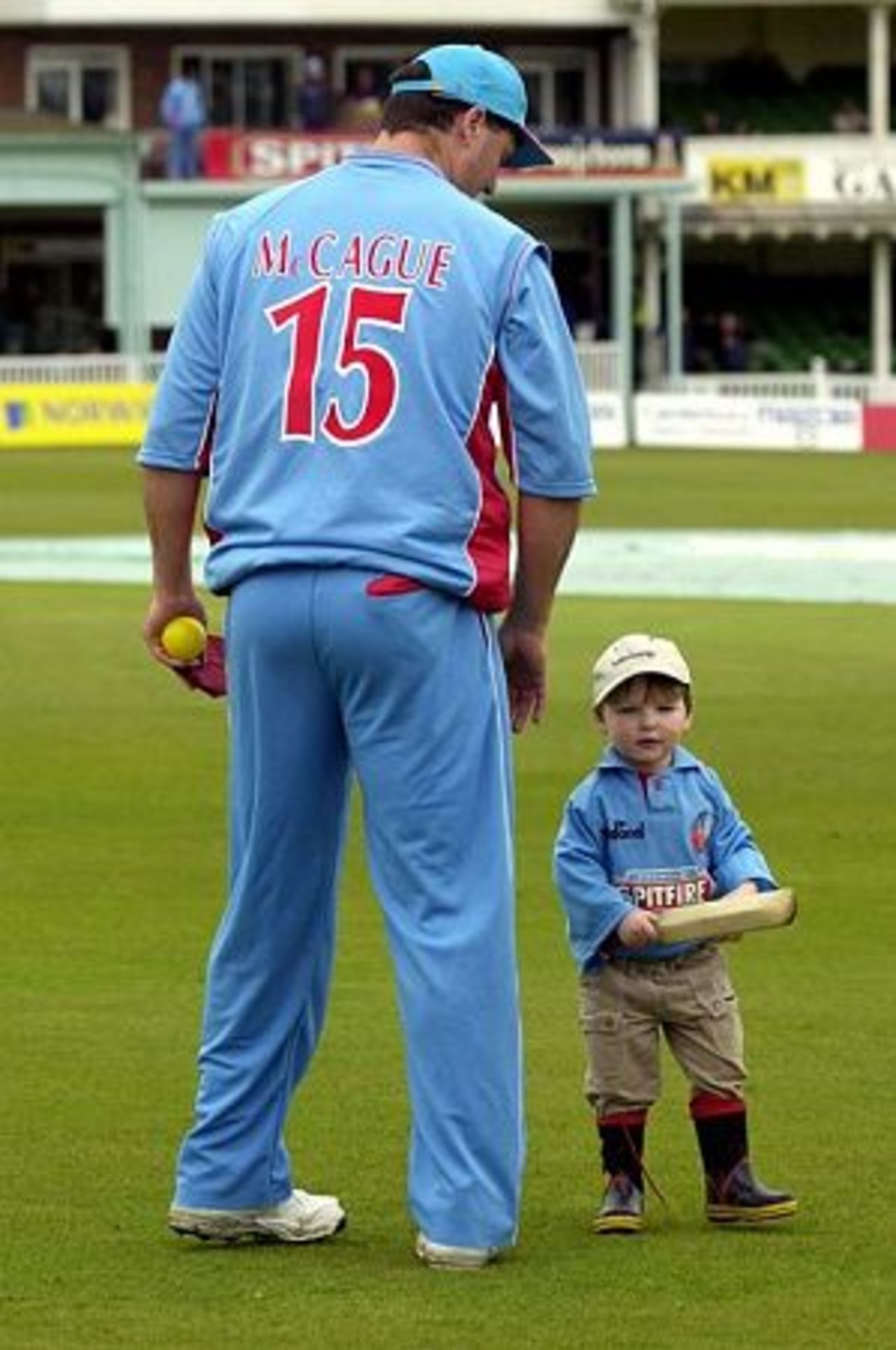 Sun 29 April 2001: Former England player Martin McCague waits with his two year old son Monte for play to start in the Norwich Union League Division One match against Warwickshire at Canterbury