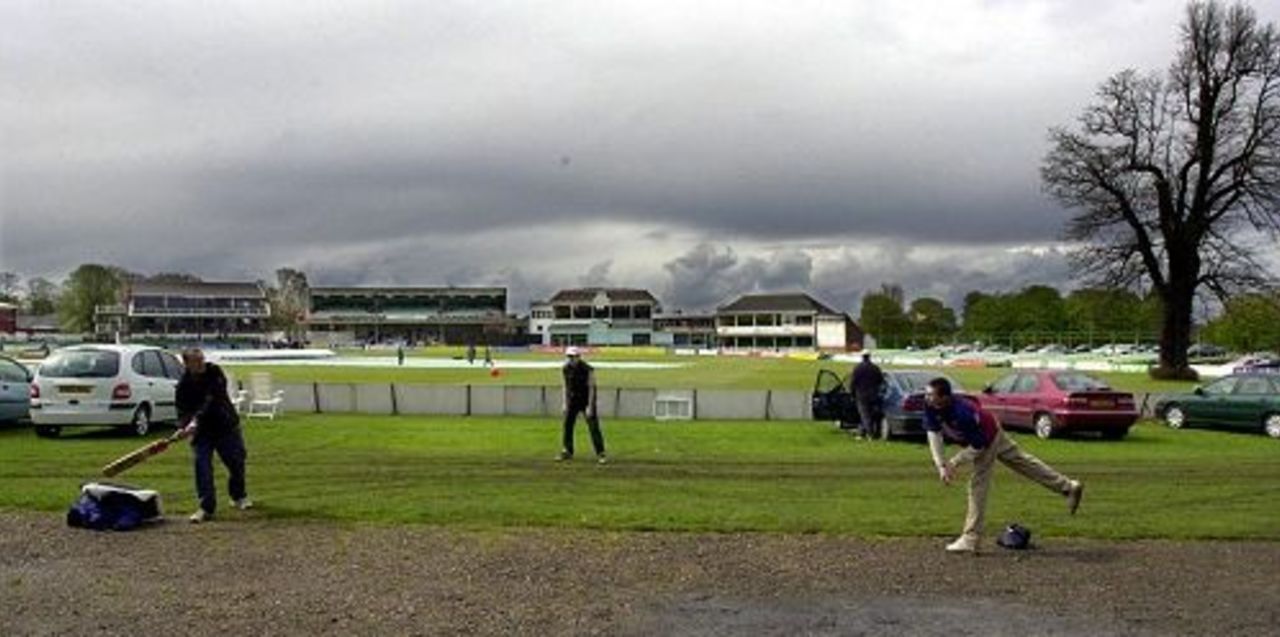 Sun 29 April 2001: Spectators play cricket at Canterbury as they waited for play to start in the Norwich Union League Division One match against Warwickshire. The match was abandoned due to rain.