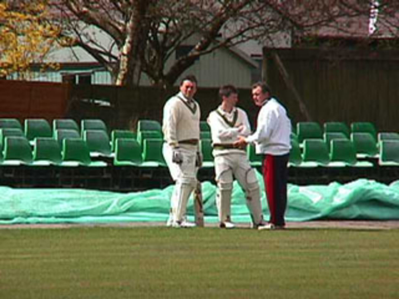Rishton captain Peter Sleep discussing tactics with openers John Seedle and John Wharton