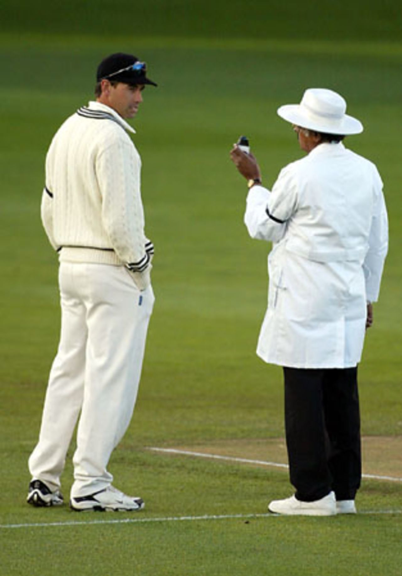 New Zealand captain Stephen Fleming looks at umpire Srinivas Venkataraghavan from India as he checks the light. 3rd Test: New Zealand v England at Eden Park, Auckland, 30 March-3 April 2002 (1 April 2002).