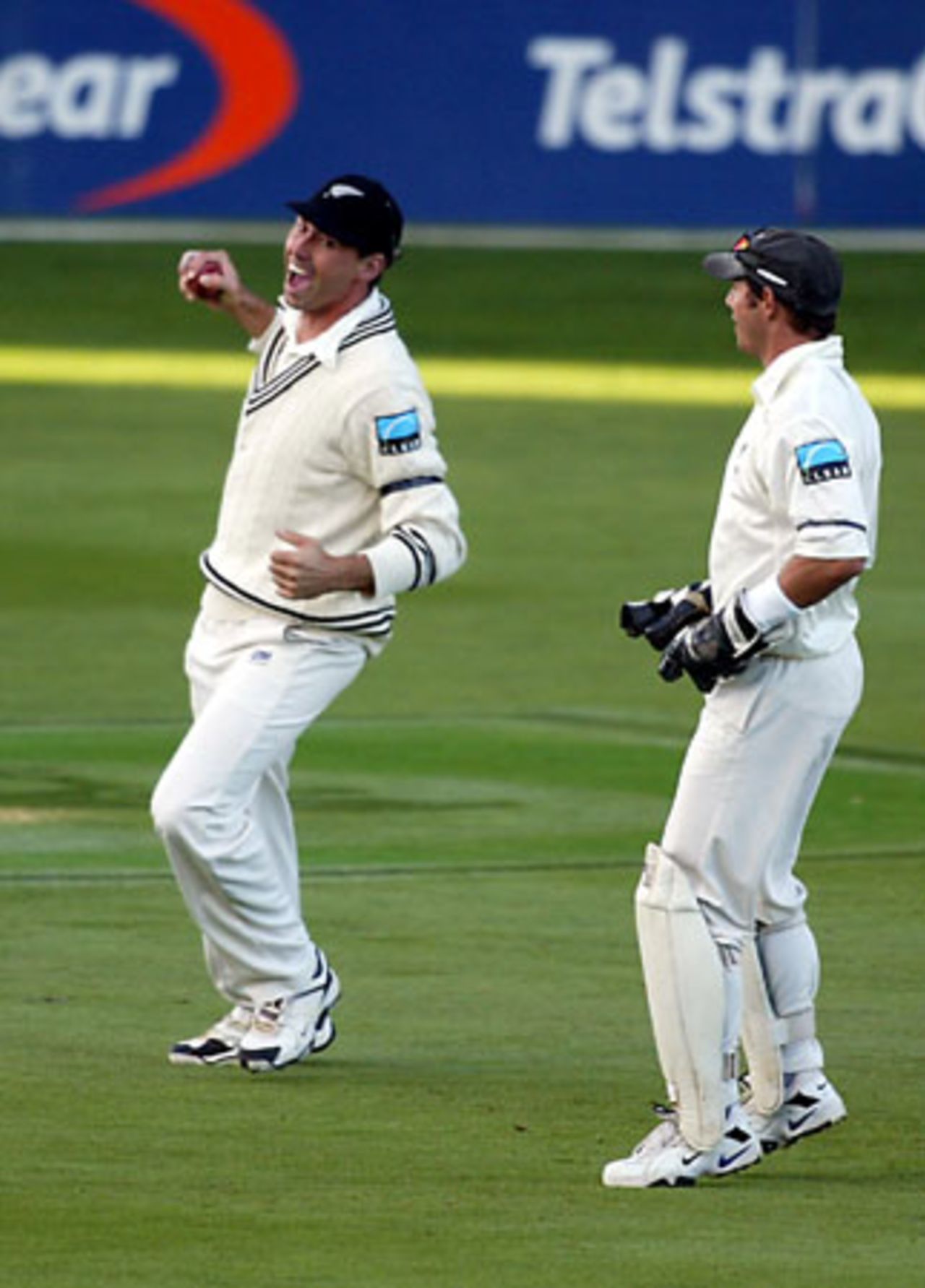 New Zealand fielder Stephen Fleming (left) celebrates the dismissal of England batsman Nasser Hussain, caught from the bowling of Chris Drum for two. Wicket-keeper Adam Parore looks on. 3rd Test: New Zealand v England at Eden Park, Auckland, 30 March-3 April 2002 (1 April 2002).
