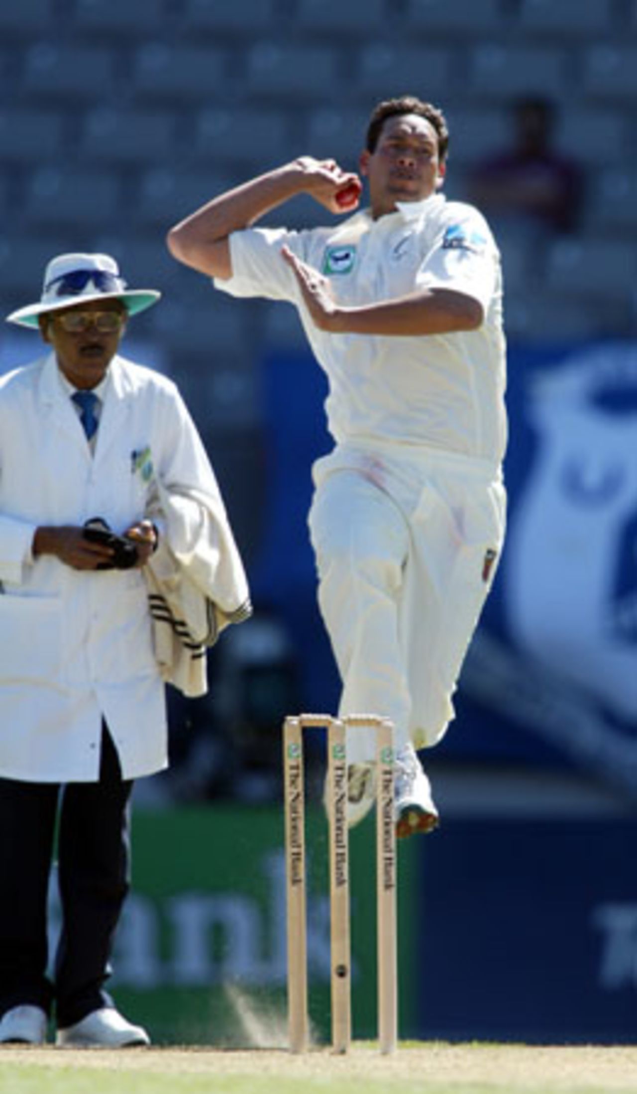 New Zealand bowler Daryl Tuffey delivers a ball during his first innings spell of 6-54 from 19 overs. Umpire Srinivas Venkataraghavan from India looks on. 3rd Test: New Zealand v England at Eden Park, Auckland, 30 March-3 April 2002 (2 April 2002).