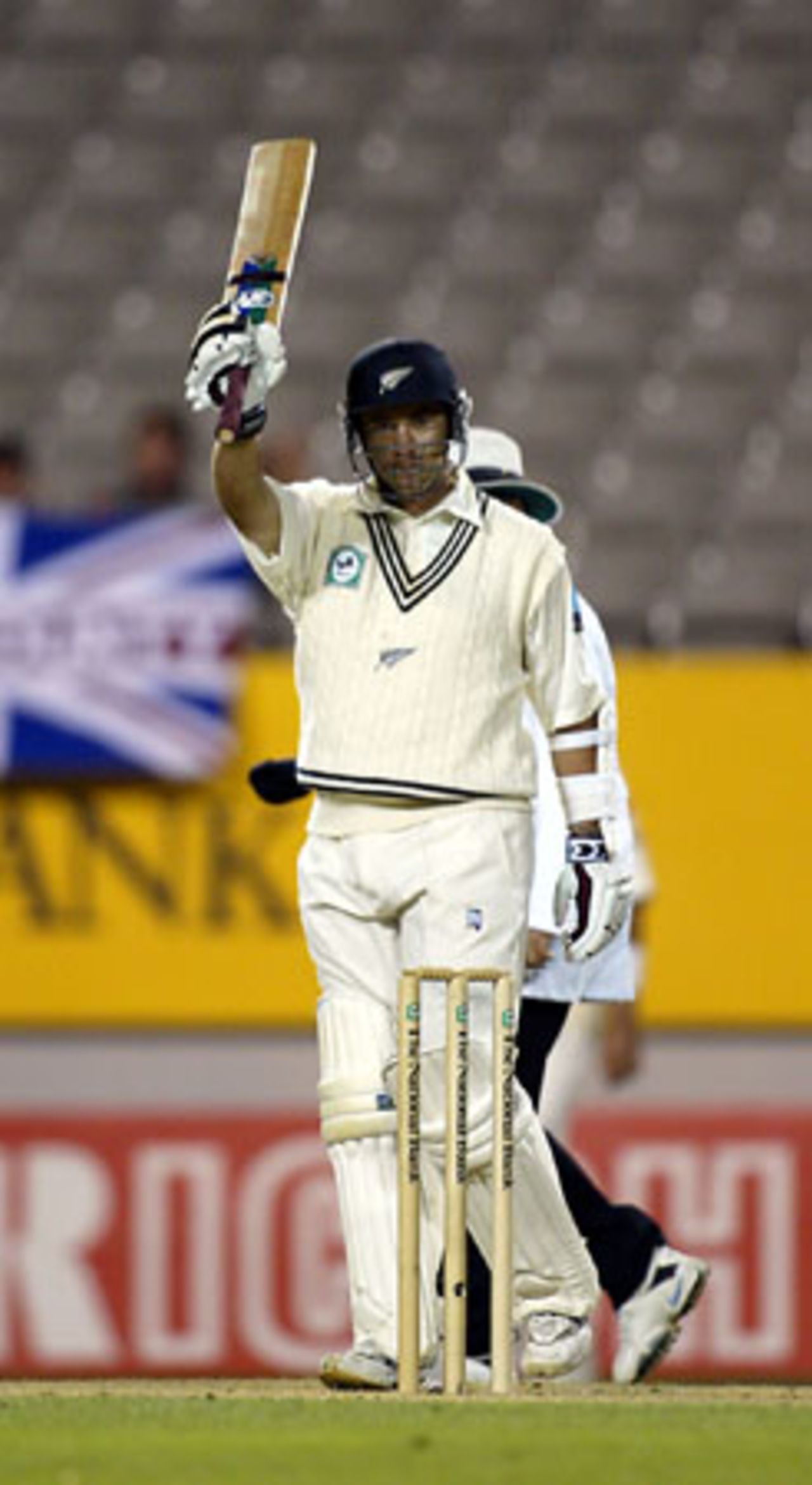 New Zealand batsman Craig McMillan raises his bat to celebrate reaching fifty in his second innings. McMillan ended the fourth day's play on 50 not out. 3rd Test: New Zealand v England at Eden Park, Auckland, 30 March-3 April 2002 (2 April 2002).