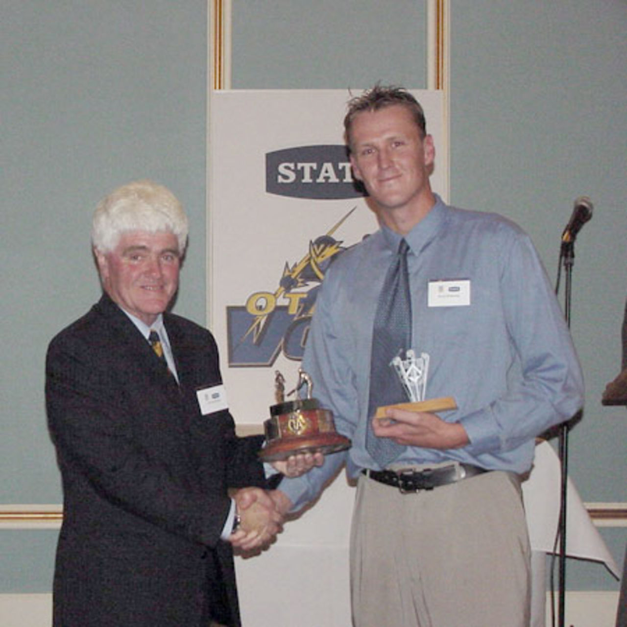 Kerry Walmsley (right) is presented the Peter Dick Trophy for the 2001/02 Otago cricketer of the year by Otago Cricket Association president Warren Shirley. 9 April 2002.