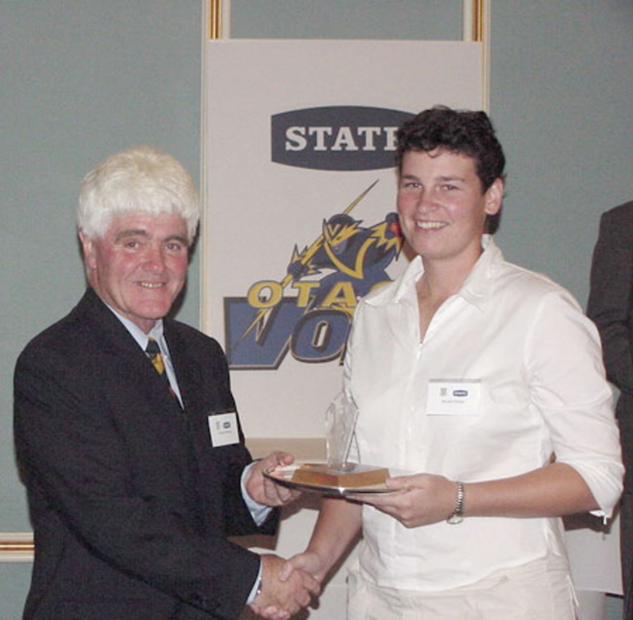 Rachel Pullar (right) is presented the 2001/02 Otago women's player of the year award by Otago Cricket Association president Warren Shirley. 9 April 2002.