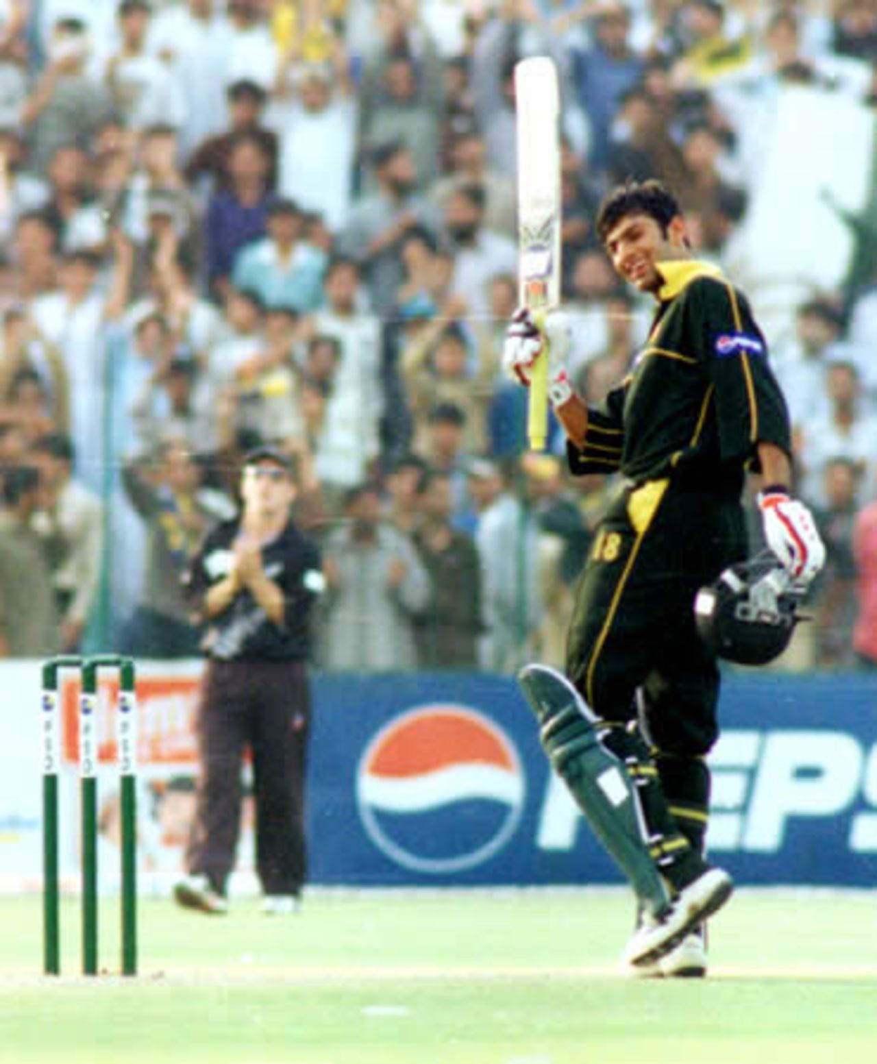 Shoaib Malik acknowledges the cheers after his 100 - 3rd ODI at Lahore, New Zealand v Pakistan, 27 Apr 2002