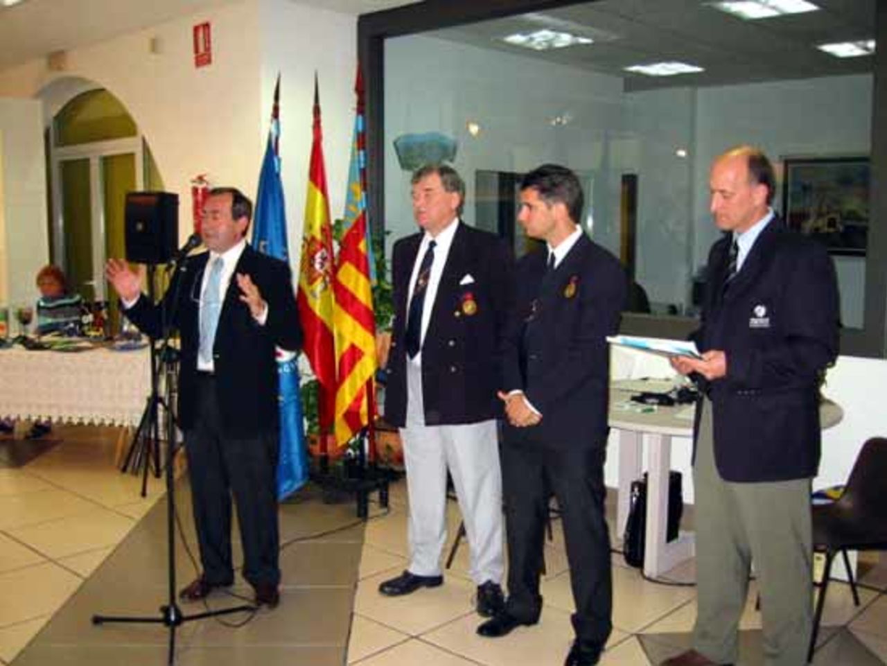 The Mayor of Alfaz del Pi addresses the reception, with Ken Sainsbury (Chairman AEC), Jaime Gonzalez (Development Officer, AEC), and Ian Stuart (EDM) looking on.