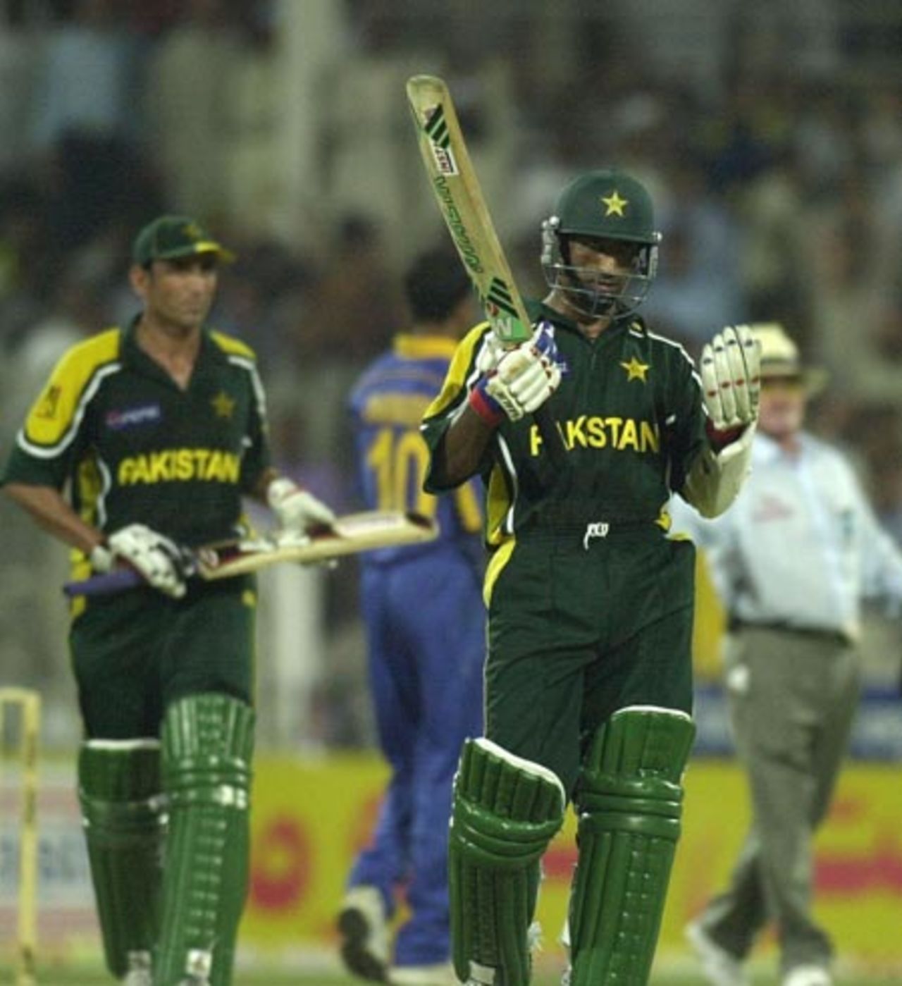 Pakistan's key player Yousuf Youhana (C) prays after Pakistan win the 2nd one-day against Sri Lanka in the four-nation Sharjah cricket tournament 04 April 2003.