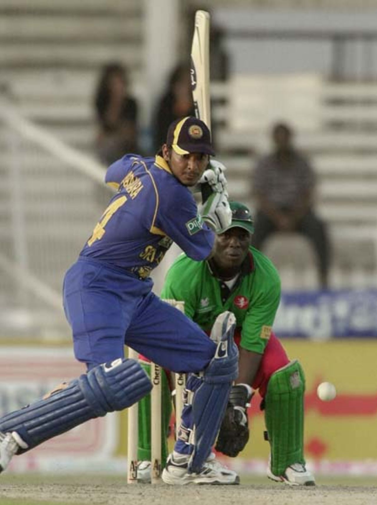 Sri Lankan top scorer Kumar Sangakkara (F) plays for a boundary during his unbeaten 103 runs inning against Kenya in the 4th one-day match of the Four Nation Sharjah Cricket Tournament, 06 April 2003.