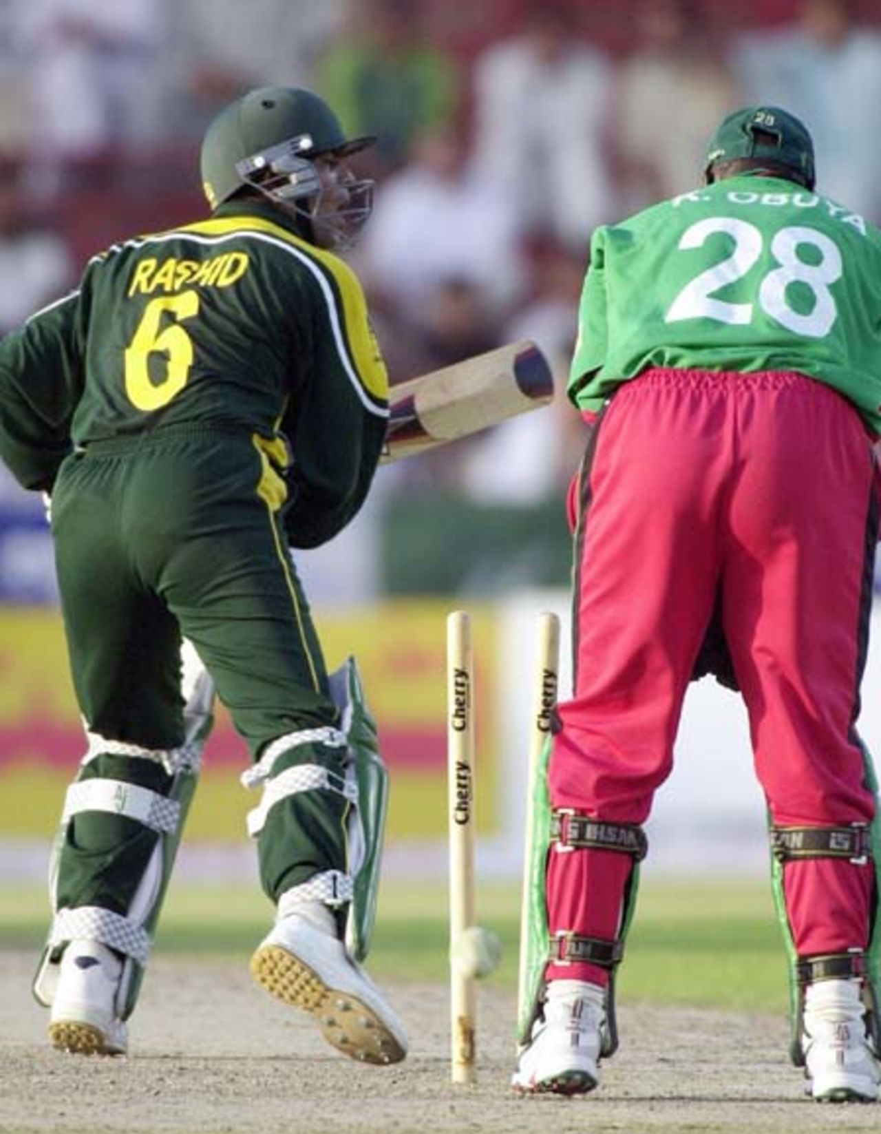 Pakistani captain Rashid Latif (L) loses his stumps off the bowling of Kenyan spinner Steve Tikolo during the sixth one-day match of the Four Nation Sharjah Cricket Tournament, 08 April 2003.