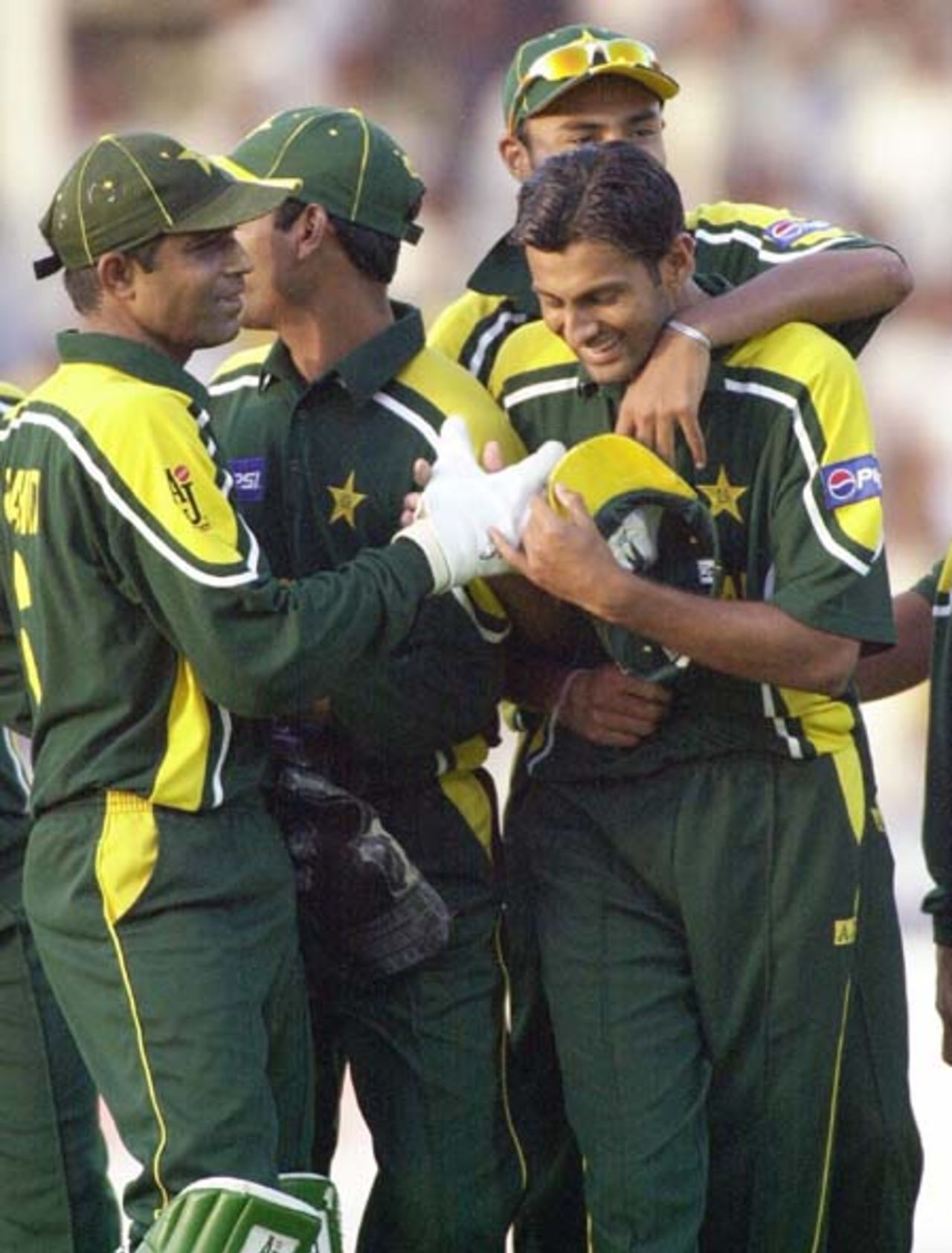 Pakistani captain Rashid Latif (L) greets his spinner Shoaib Malik (R) on his third wicket of Zimbabwe's last batsman Douglas Hondo during the final one-day match of the Four Nation Sharjah Cricket Tournament, 10 April 2003.