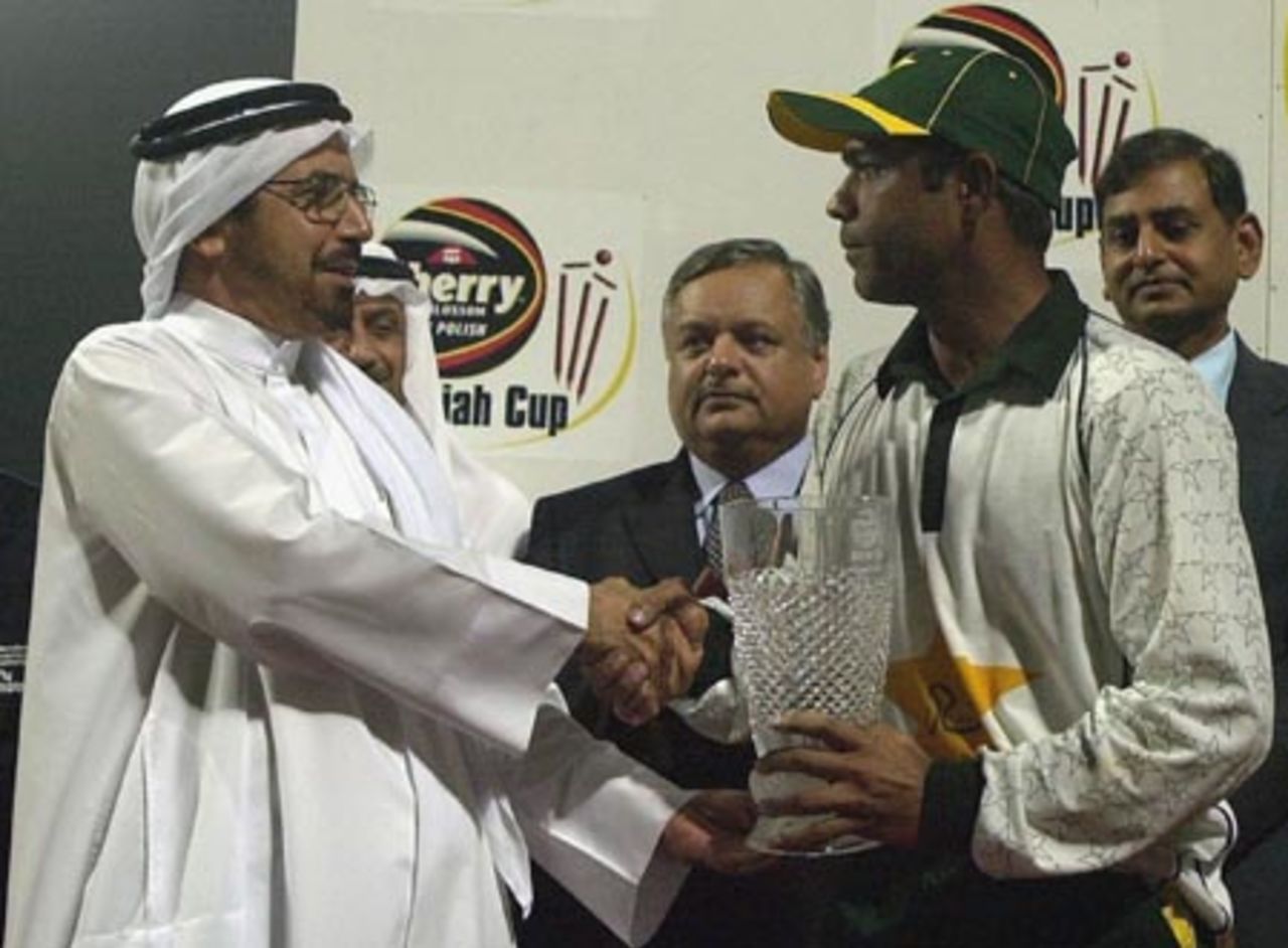 Pakistani Captain Rashid Latif (R) receives the Sharjah Cup 2003 from Abdul Rehman Bukhatir, Chairman of CBFS, after defeating Zimbabwe in the Four Nation Sharjah Cricket Tournament, 10 April 2003.