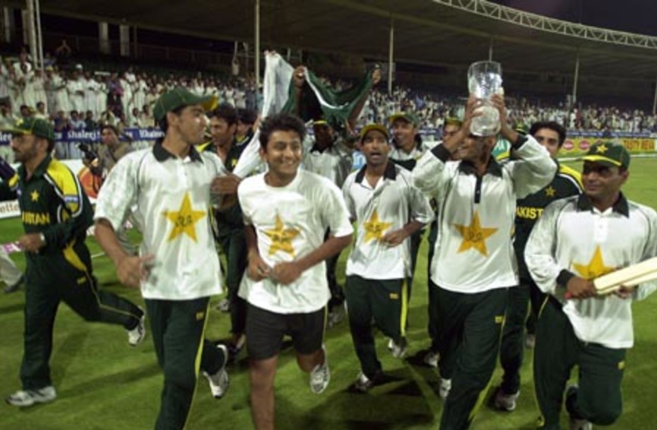 The Pakistani cricket team celebrate their victory holding the Sharjah Cup 2003 in the final of the Four Nation Sharjah Cricket Tournament, 10 April 2003.