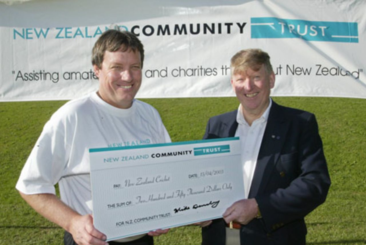 New Zealand Cricket chief executive Martin Snedden (left) receives a cheque for the New Zealand Community Trust's $250,000 sponsorship of the NZC secondary schools and club development programme from New Zealand Community Trust trustee Mike Dearsley. A New Zealand Cricket Invitational XI played a Parliamentary XI at Wellington College in Wellington to launch the New Zealand Community Trust's $250,000 sponsorship of the NZC secondary schools and club development programme. 13 April 2003.