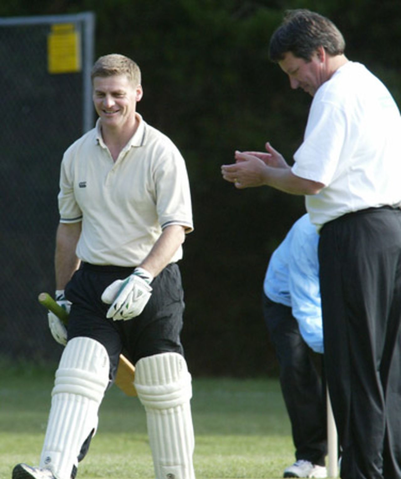 Opposition leader Bill English is applauded by New Zealand Cricket chief executive Martin Snedden as he leaves the field after being dismissed. A New Zealand Cricket Invitational XI played a Parliamentary XI at Wellington College in Wellington to launch the New Zealand Community Trust's $250,000 sponsorship of the NZC secondary schools and club development programme. 13 April 2003.
