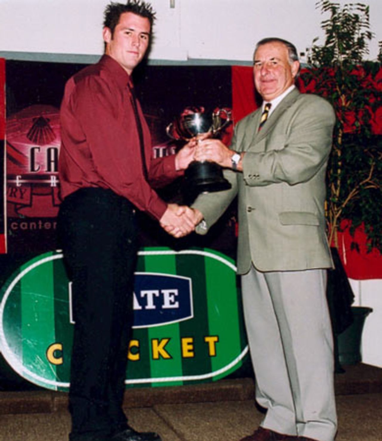 St Albans wicket-keeper Aaron Johnstone (left) receives the Chattel Hayes Memorial Trophy for most wicket-keeping dismissals in men's first grade from Canterbury Cricket Association president Brian Adams. Canterbury Cricket Association Awards 2002/03 at the Canterbury Horticultural Society Hall at Christchurch, 10 April 2003.
