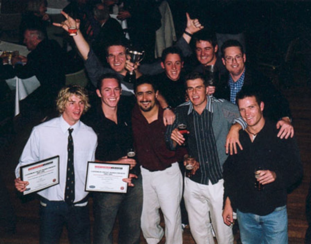 Members of the Old Collegians second grade men's team celebrate after collecting the trophies for winning the second grade one-day and two-day competitions. Canterbury Cricket Association Awards 2002/03 at the Canterbury Horticultural Society Hall at Christchurch, 10 April 2003.