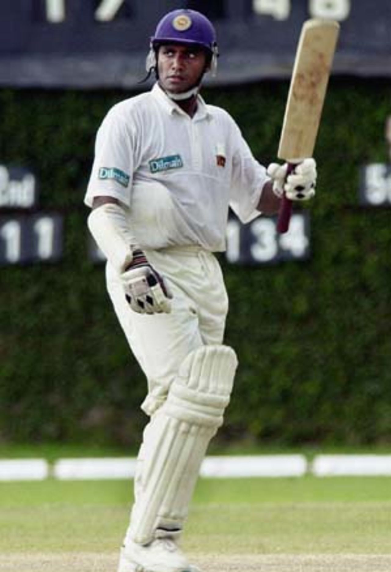 Hashan Tillakaratne raises his bat to acknowledge cheers from the crowd on reaching his half century at Colombo, 27 April 2003