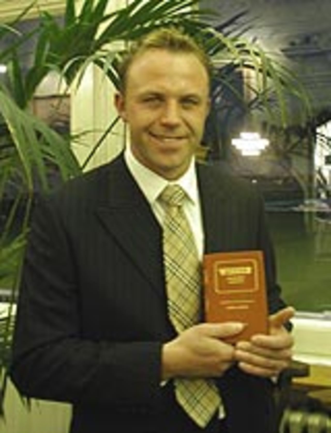Chris Adams receives his leather-bound almanack as one of Wisden's Five Cricketers of the Year, April 7, 2004