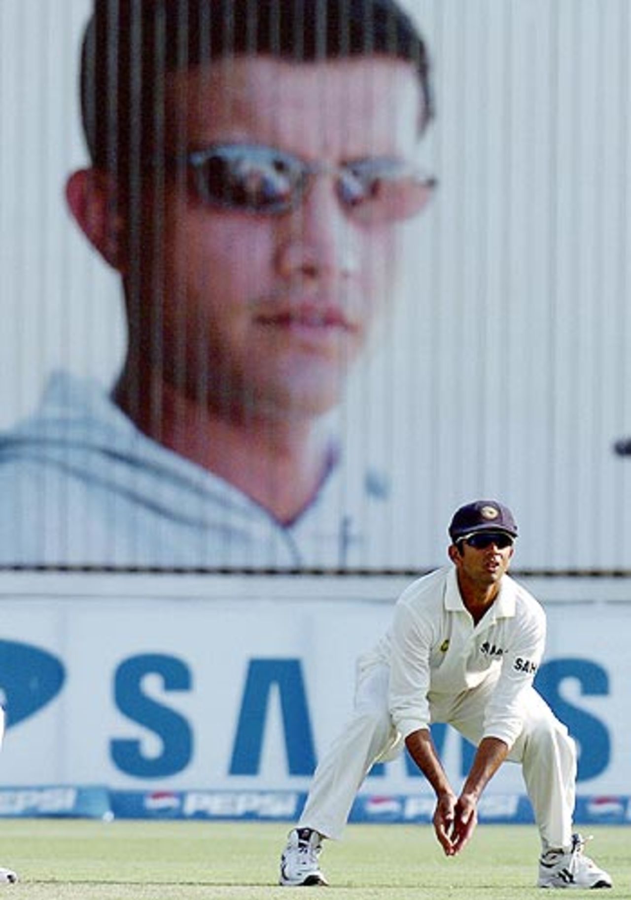 He's not there but he's watching you ... - A Sourav Ganguly hoarding towers over Rahul Dravid, Pakistan v India, 1st Test, Multan, 3rd day, March 30, 2004