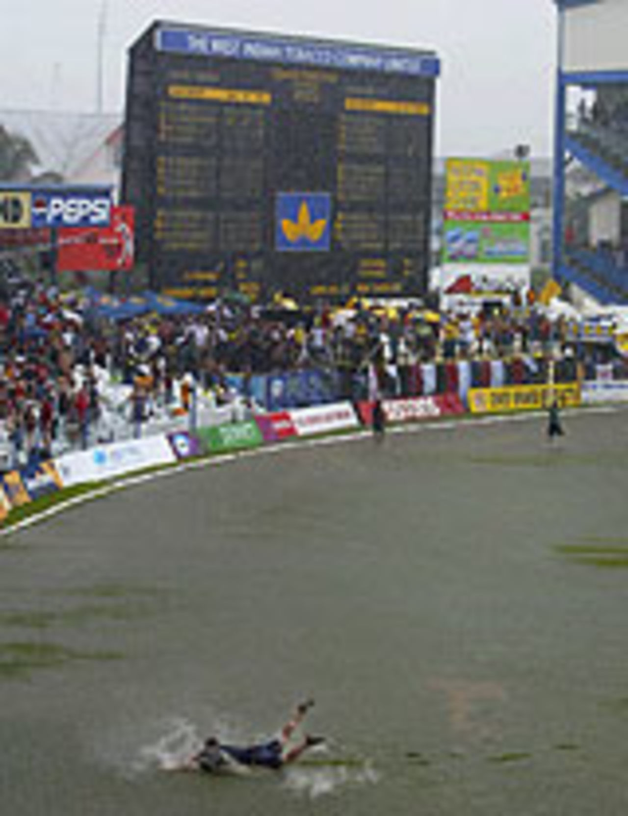A fan swims in the outfield, as the second one-day international in Trinidad came to a soggy end