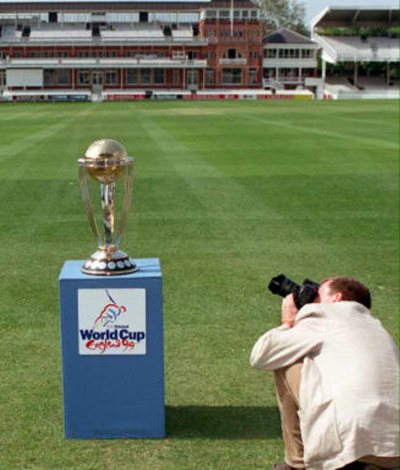 A member of the media photographs the Cricket World Cup Trophy  during a photocall at Lord's Cricket ground in London 04 May1999