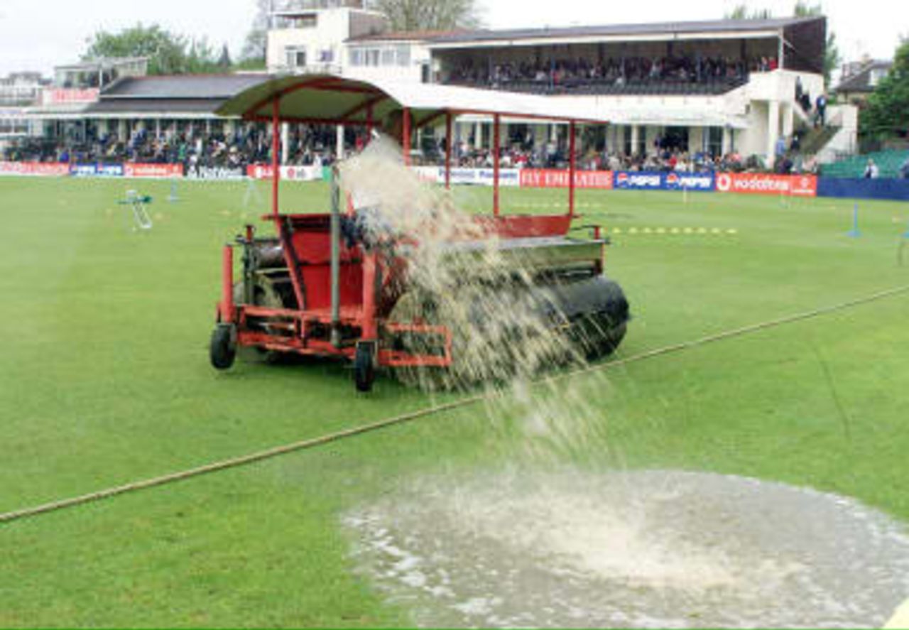 A water hog sprays water from the rain soaked  Hove pitch  which prevented play in the Sussex - South Africa World Cup warm up match  07 May 1999