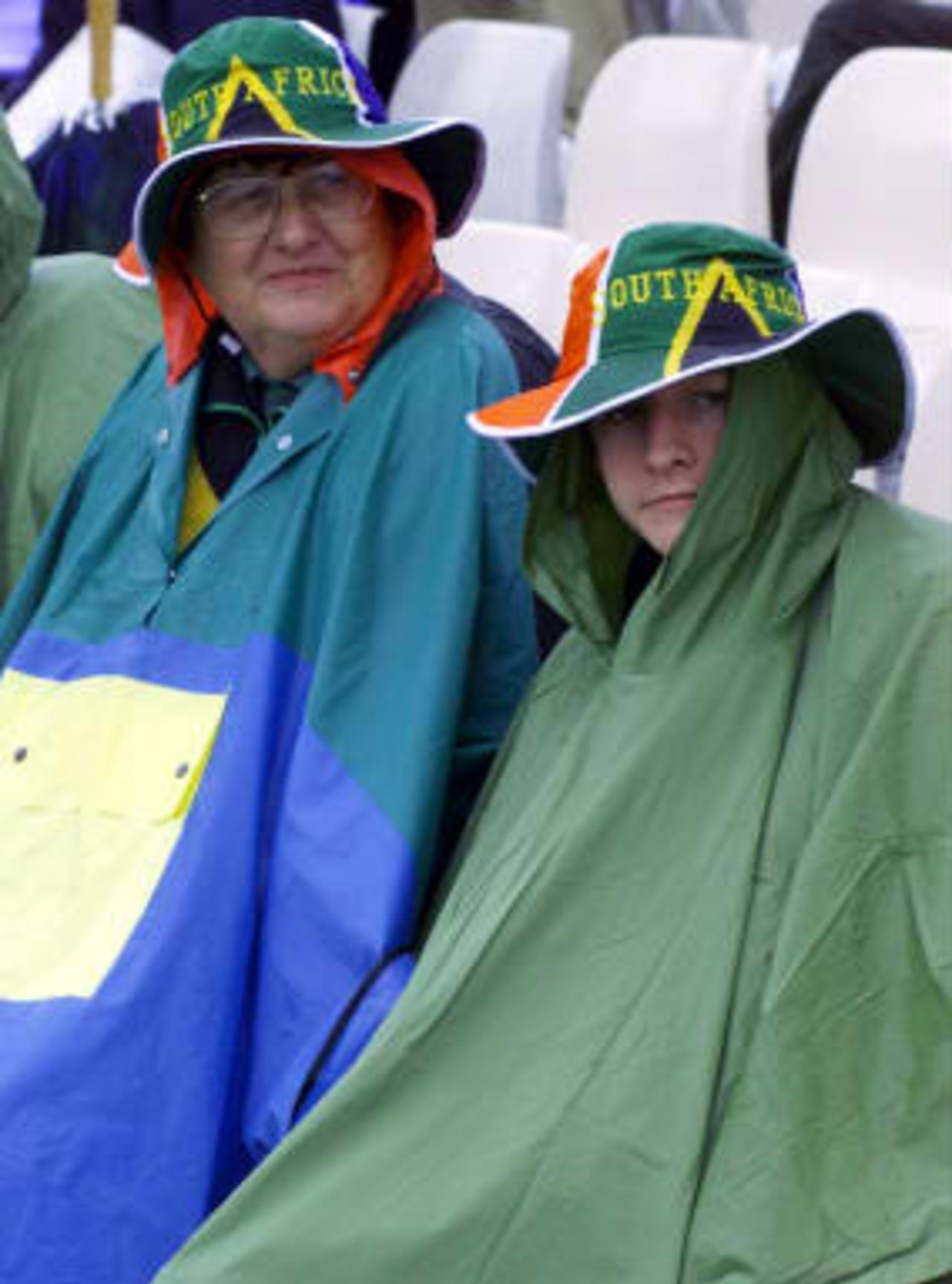 South African fans Shirley Southwood  and Andrew Marshall from Johannesburg shelter from the rain - abandoned Sussex - South Africa World Cup warm up match  07 May 1999