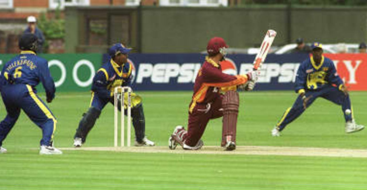 Matthew Hayden of Northampton hits out -  Kaluwitharana and  Tillekeratne look on - Sri Lanka - Northamptonshire World cup warm up game, 7 May 1999