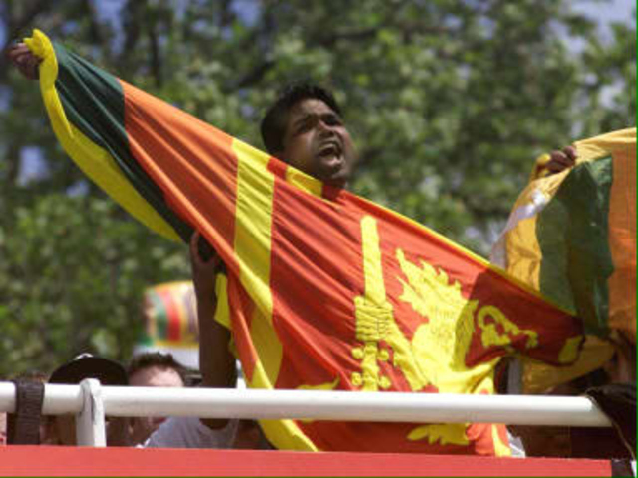 An unnamed Sri Lankan fan gets behind his team as World Cup cricket fever grips Lords in during the opening Cricket World Cup match, England vs Sri Lanka at Lord's 14 May 1999.