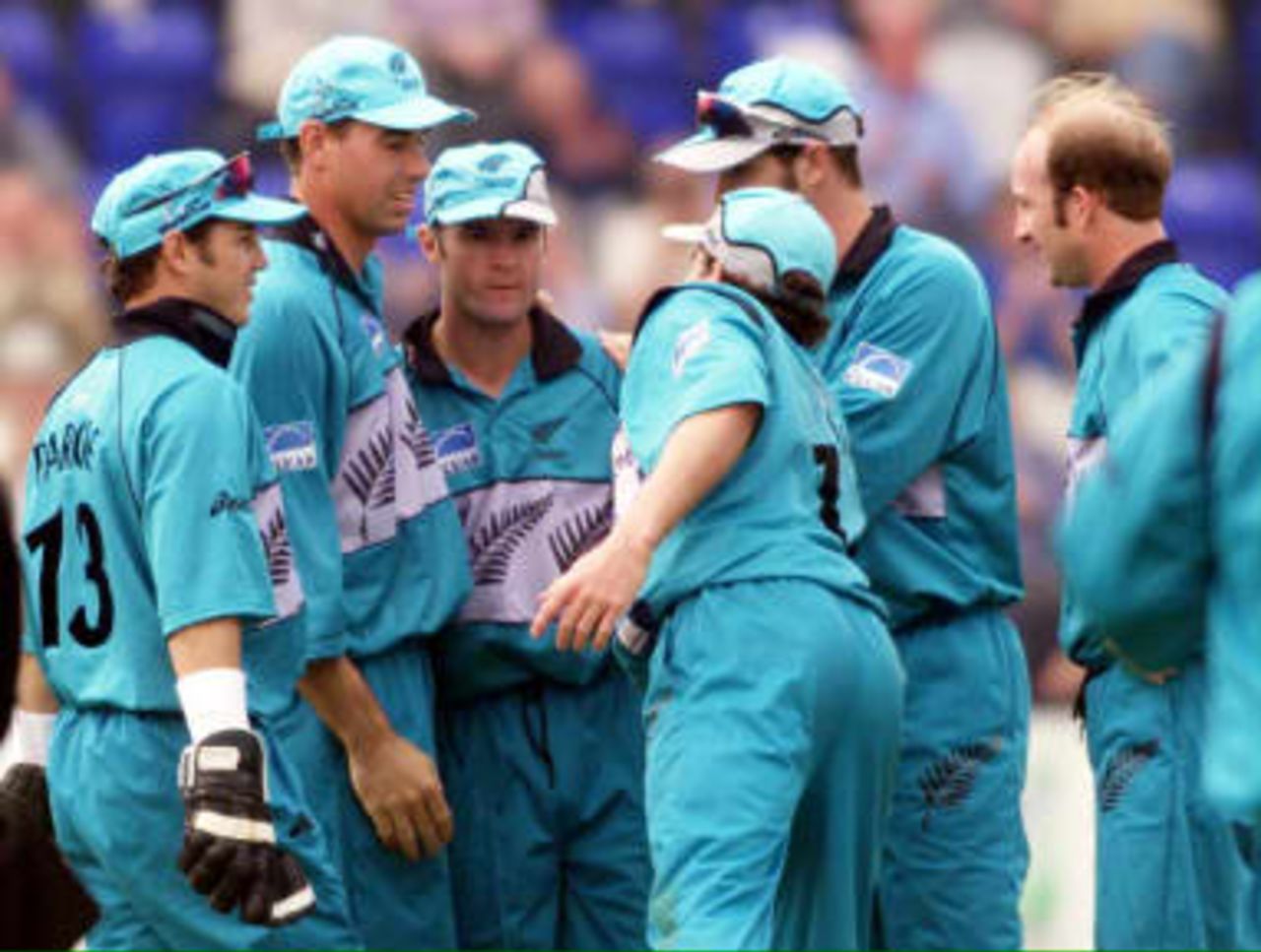 New Zealand's Nathan Astle (C) is congratulated by teammates after taking a great catch from Australia's Steve Waugh off the bowling of Chris Harris (R) 20 May 1999, during their Cricket World Cup match in Cardiff.