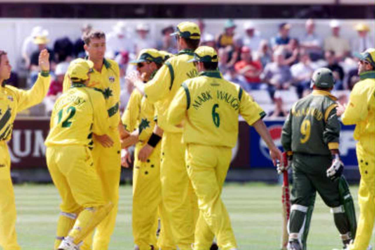 Australian fast bowler Glenn McGrath is congratulated after bowling Bangladesh opening batsman Khaled Mahmud (Walking away) LBW 27 May 1999, during their Cricket World Cup match at Chester le Street. The final will be played at Lords on 20 June.
