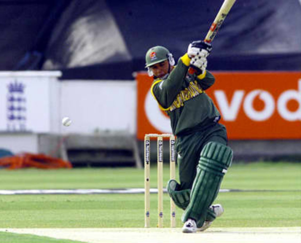 Bangladesh opening batsman Khaled Mahmud hits out off the bowling of Australia's Damien Fleming 27 May 99, during their Cricket World Cup match at Chester Le Street