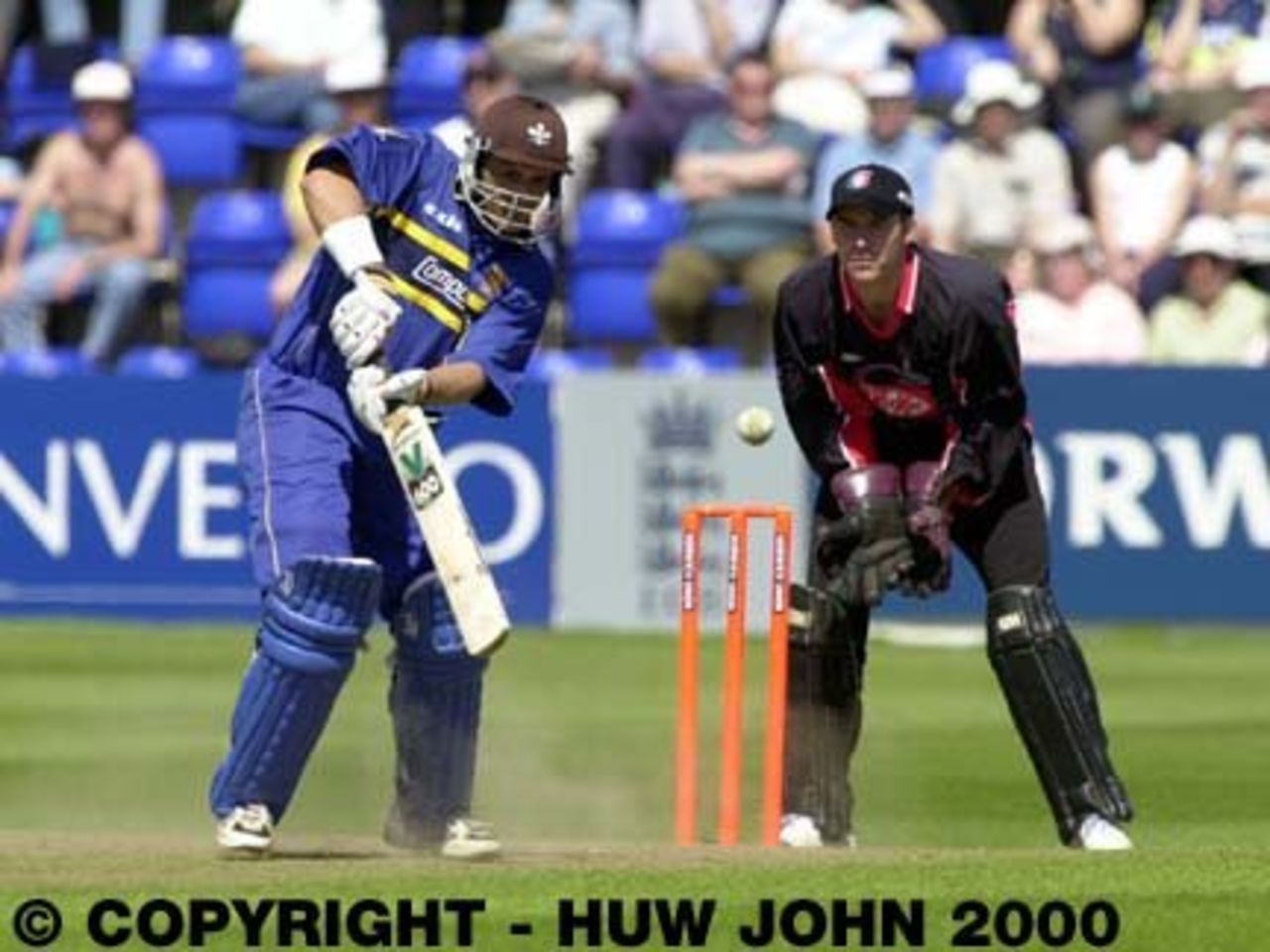 Mark Butcher hits a boundary watched by Adrian Shaw, National League 30 Apr 2000