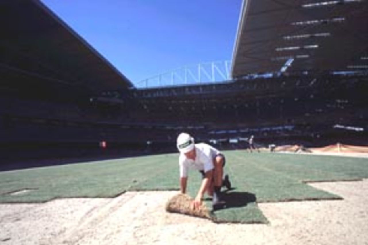 12 Jan 2000: Damien Fox turf manager for Strath Ayr lays the first strips of turf at Colonial Stadium. The stadium will be the new home of AFL football in the future in Melbourne,Australia.