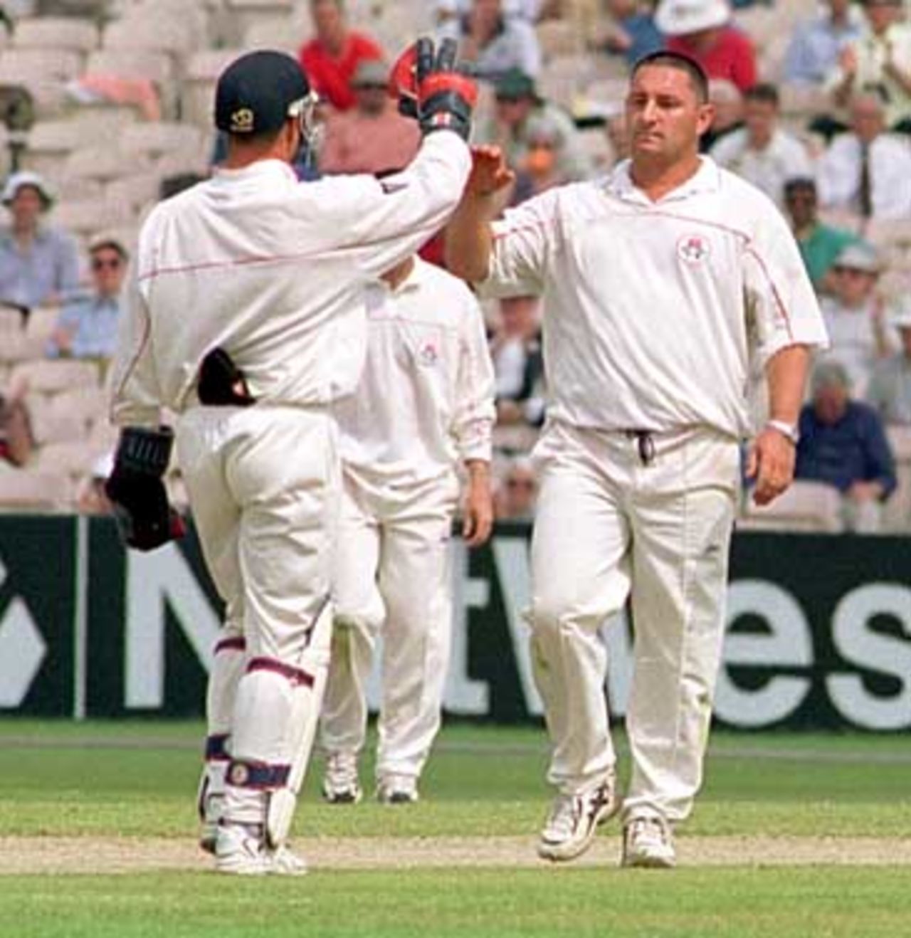 Ian Austin congratulated by Hegg after bowling out Paul Collingwood