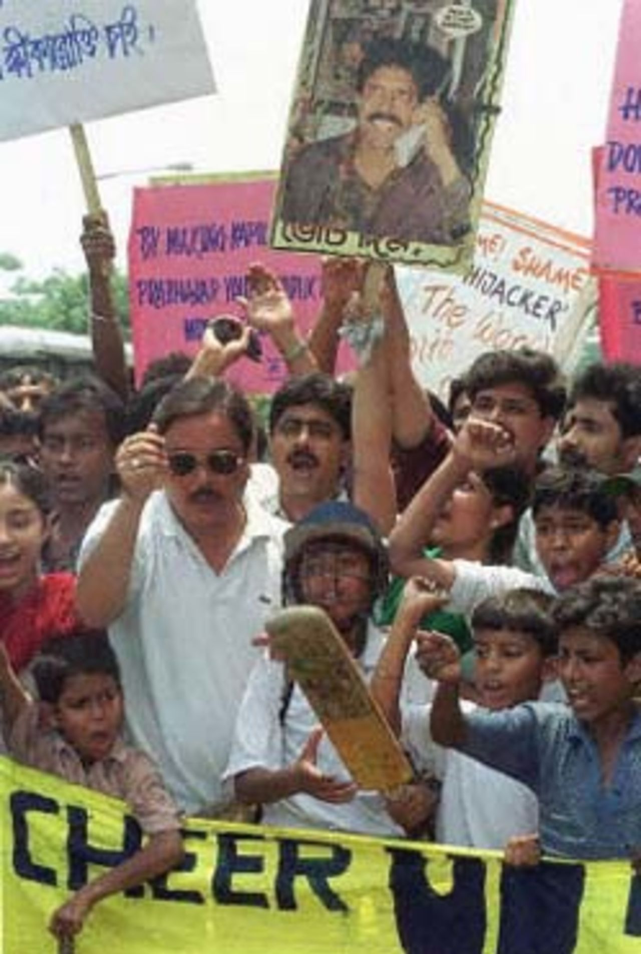 Sports lovers in Calcutta shout slogans during a protest against former Test cricketer Manoj Prabhakar and former Indian cricket chief Inderjit Singh Bindra, who leveled match-fixing allegations against Indian cricket icon Kapil Dev. Dev, the current coach of the Indian national team, had denied the charges and threatened legal action 12 May 2000.