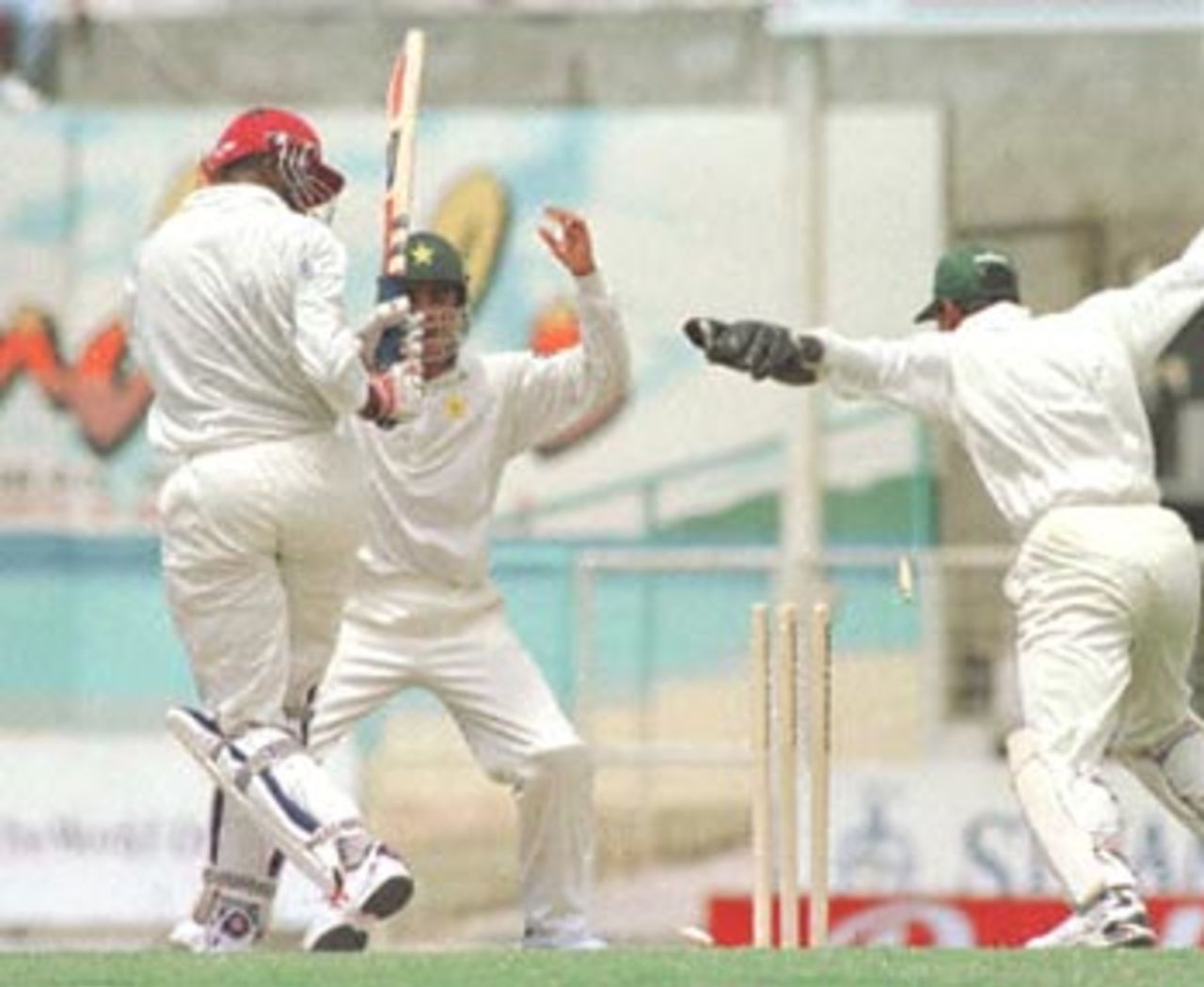 The West Indies' A. Griffith (L) is bowled by Pakistan's Mushtaq Ahmed (R) 26 May, 2000, during the second day of the third and deciding test against Pakistan. Pakistan in West Indies 1999/00, 3rd Test, West Indies v Pakistan, Antigua Recreation Ground, St John's, Antigua, (25-29 May 2000) Day 2