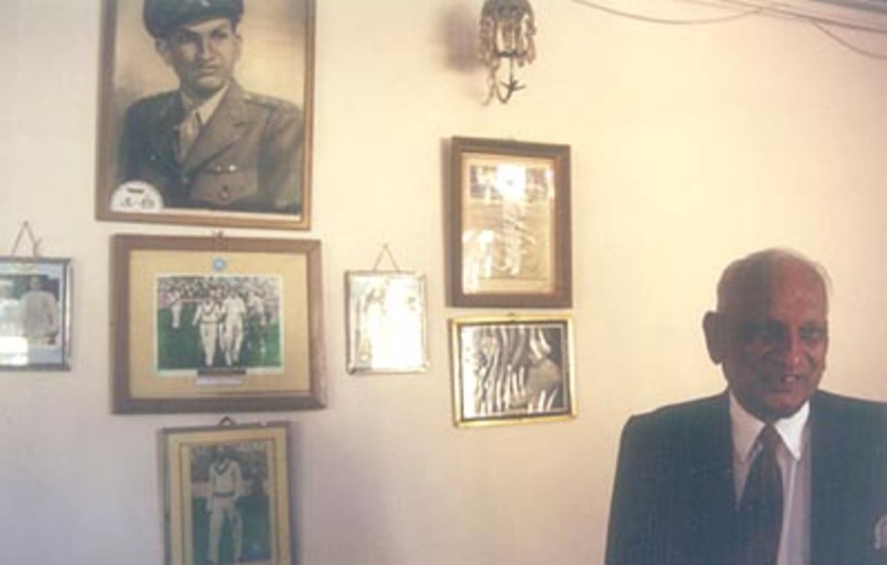 Mushtaq Ali stands in front of pictures taken during his playing days, Indore, December 1999