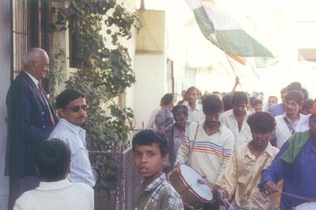 Mushtaq Ali watches intently as a local procession passes by, Indore, December 1999