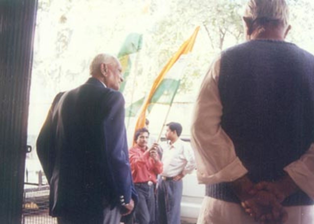 Mushtaq Ali (L) looks on as Indian flags are waved, Indore, December 1999