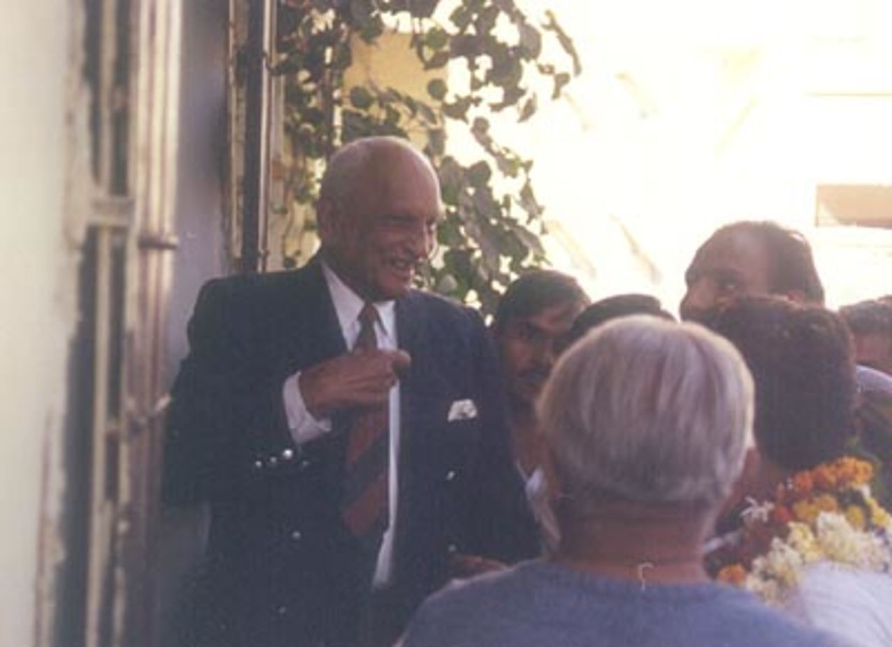 Mushtaq Ali talks to a local politician, Indore, December 1999