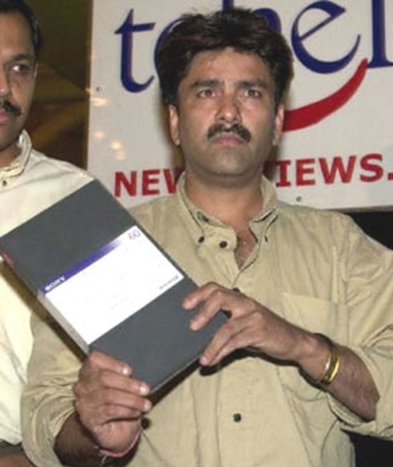 Former Indian all-round cricketer Manoj Prabhakar exhibits a video tape at a press conference in New Delhi, 27 May 2000, to press his match-fixing allegations against Indian cricketing icon Kapil Dev. Prabhakar said Dev had offered him 2.5 million rupees (58,139 USD) in 1994 to throw a match against Pakistan.