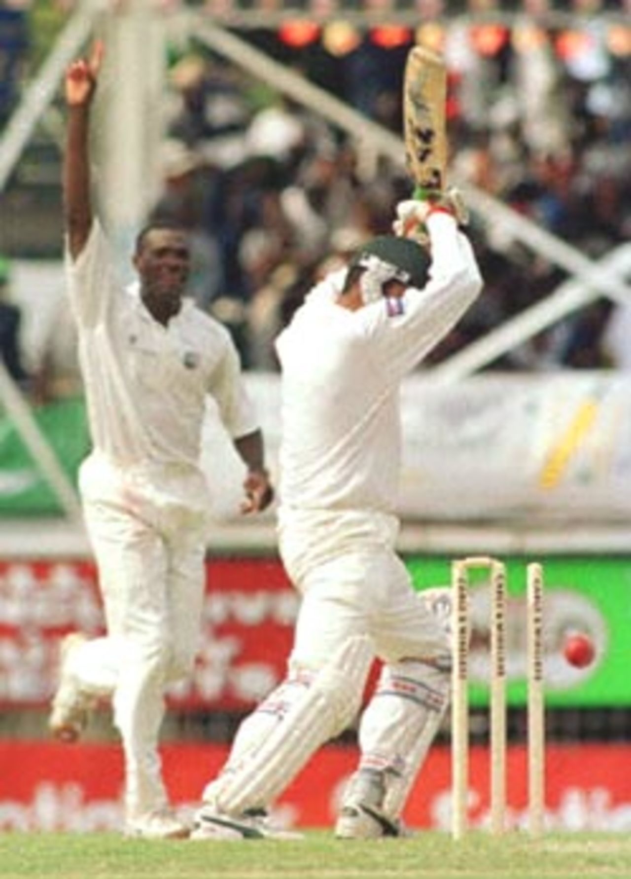 Pakistan's Mohammad Wasim (R) is bowled by West Indies' Reon King 27 May, 2000, during the third day of the third and deciding test at Antigua. Pakistan in West Indies 1999/00, 3rd Test, West Indies v Pakistan, Antigua Recreation Ground, St John's, Antigua, (25-29 May 2000) Day 3